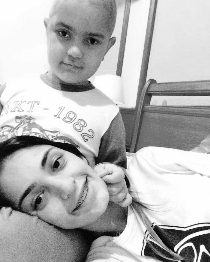 Esthevão Abner sorrindo ao lado da mãe, durante o tratamento